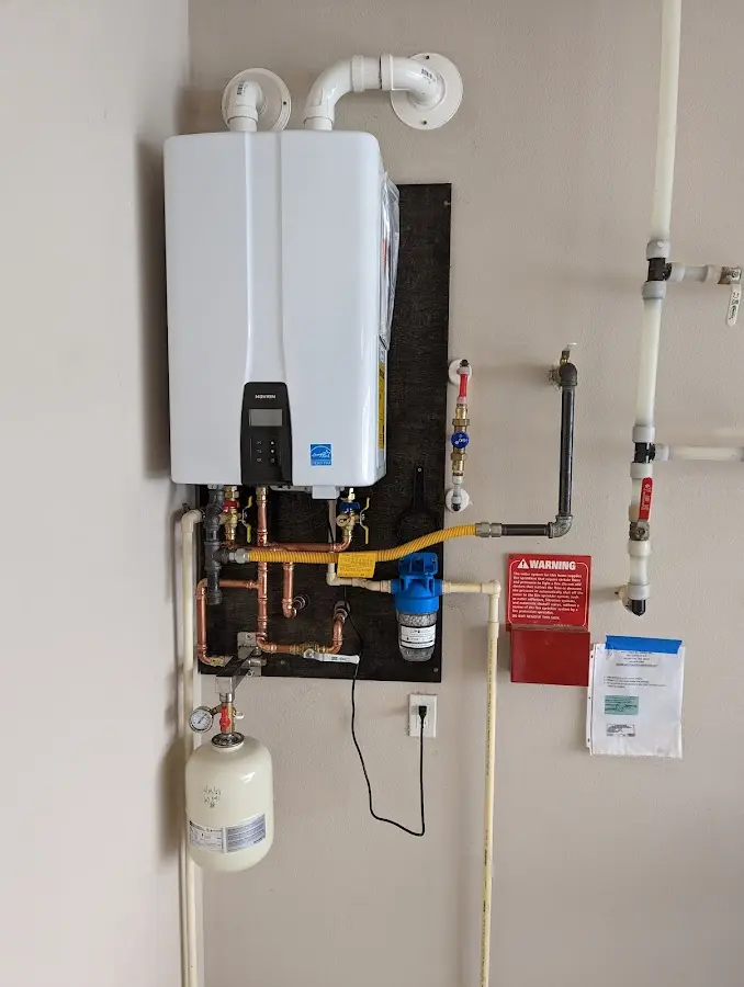 Professional plumber installing copper piping in a Lake Jackson home